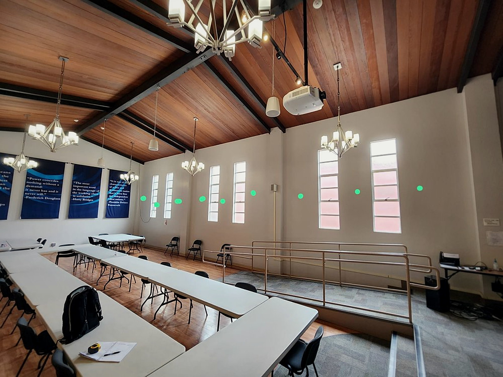 Large Oakland conference room with bare plaster walls, wood ceiling and hard surfaces before acoustic treatment