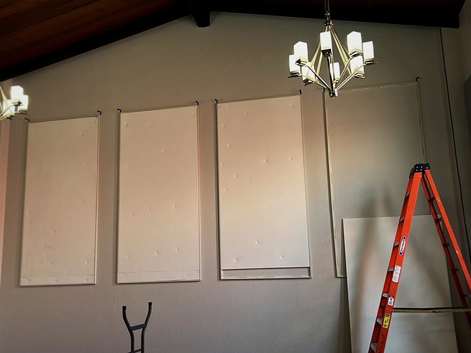 Custom fabric track frames mounted on the wall with polyboard absorption set inside, before fabric is tucked