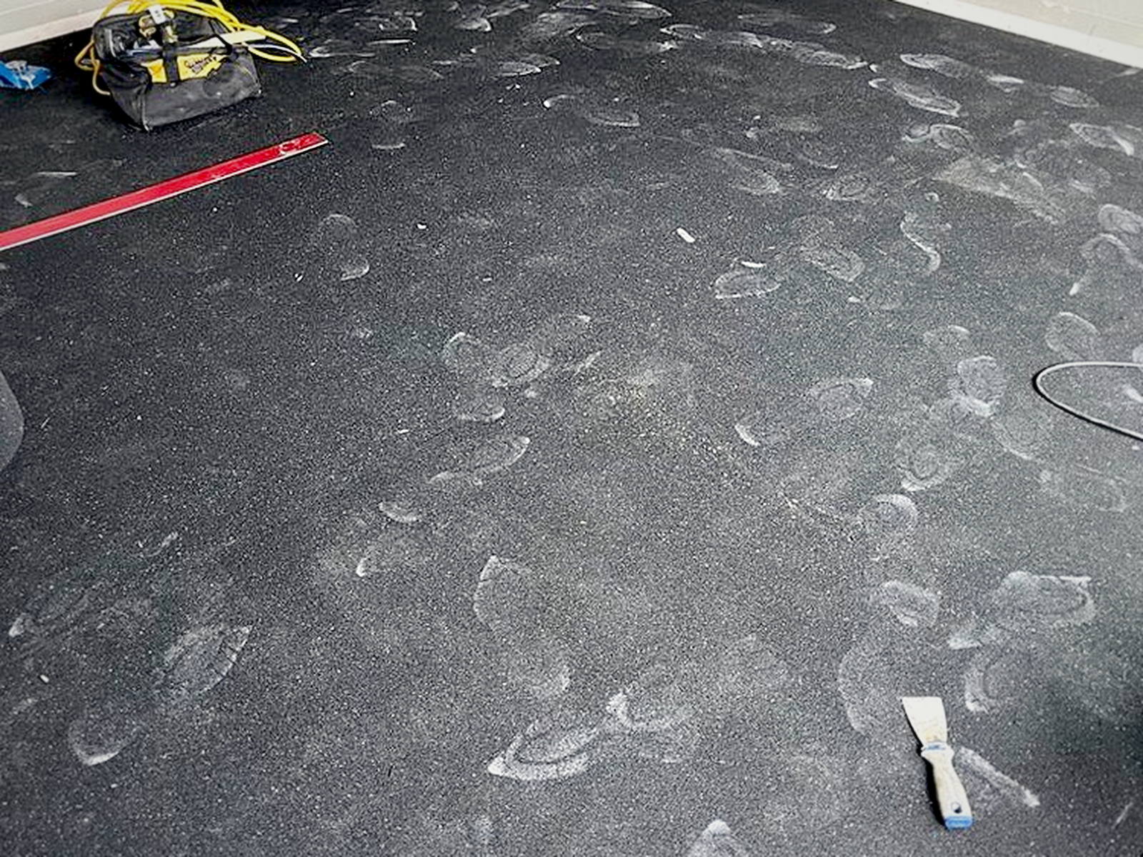 Serenity rubber acoustic underlay fully installed across a room, seams taped and ready for hardwood
