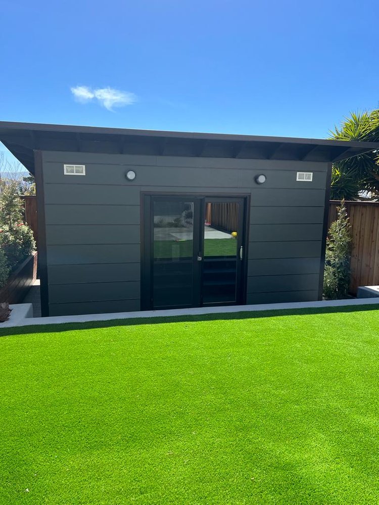 Completed soundproof backyard studio shed with sliding doors and engineered wood floor built by West Coast Sound Solutions