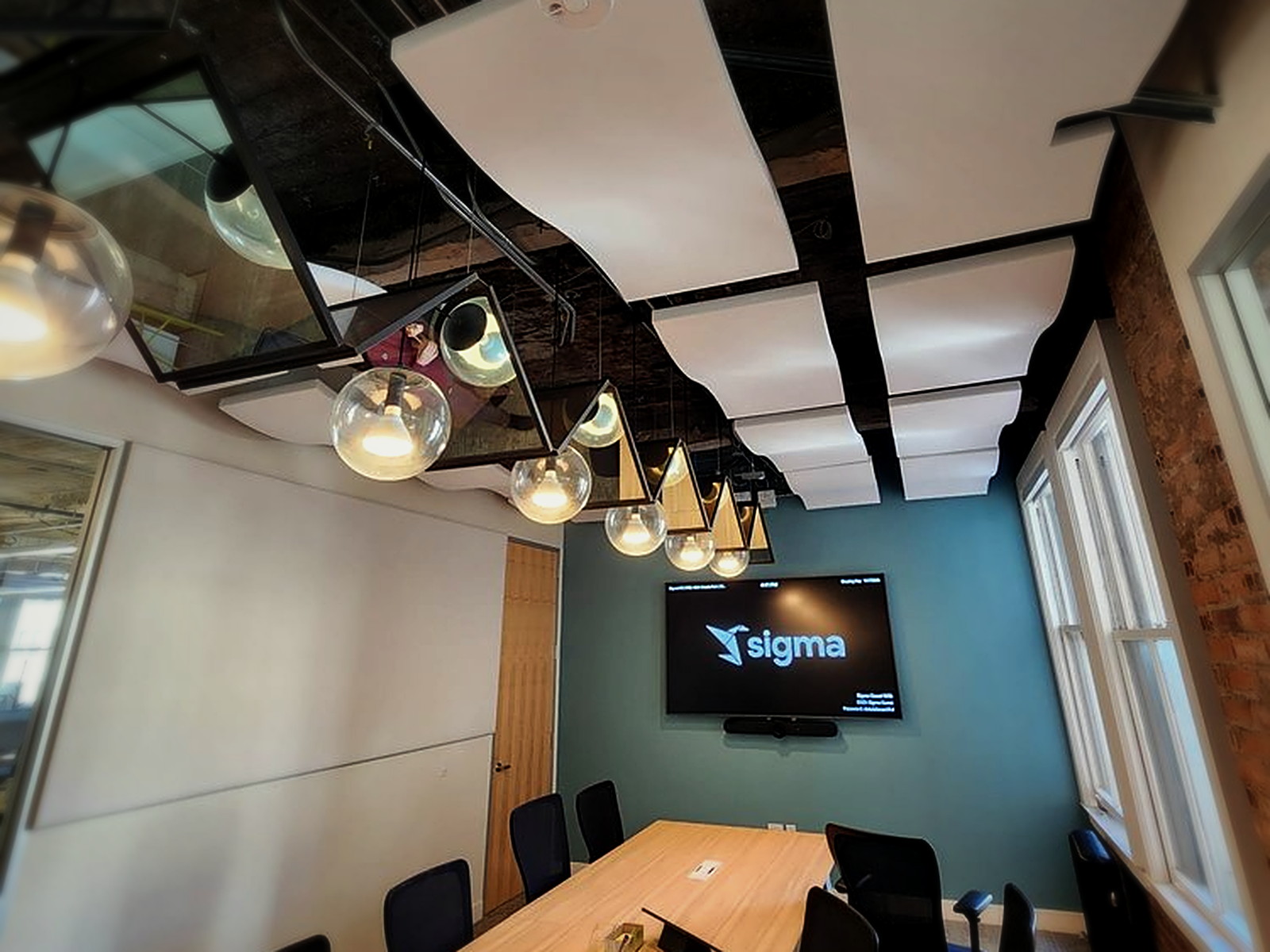 Sigma conference room, San Francisco: white wave acoustic clouds suspended under an exposed timber ceiling