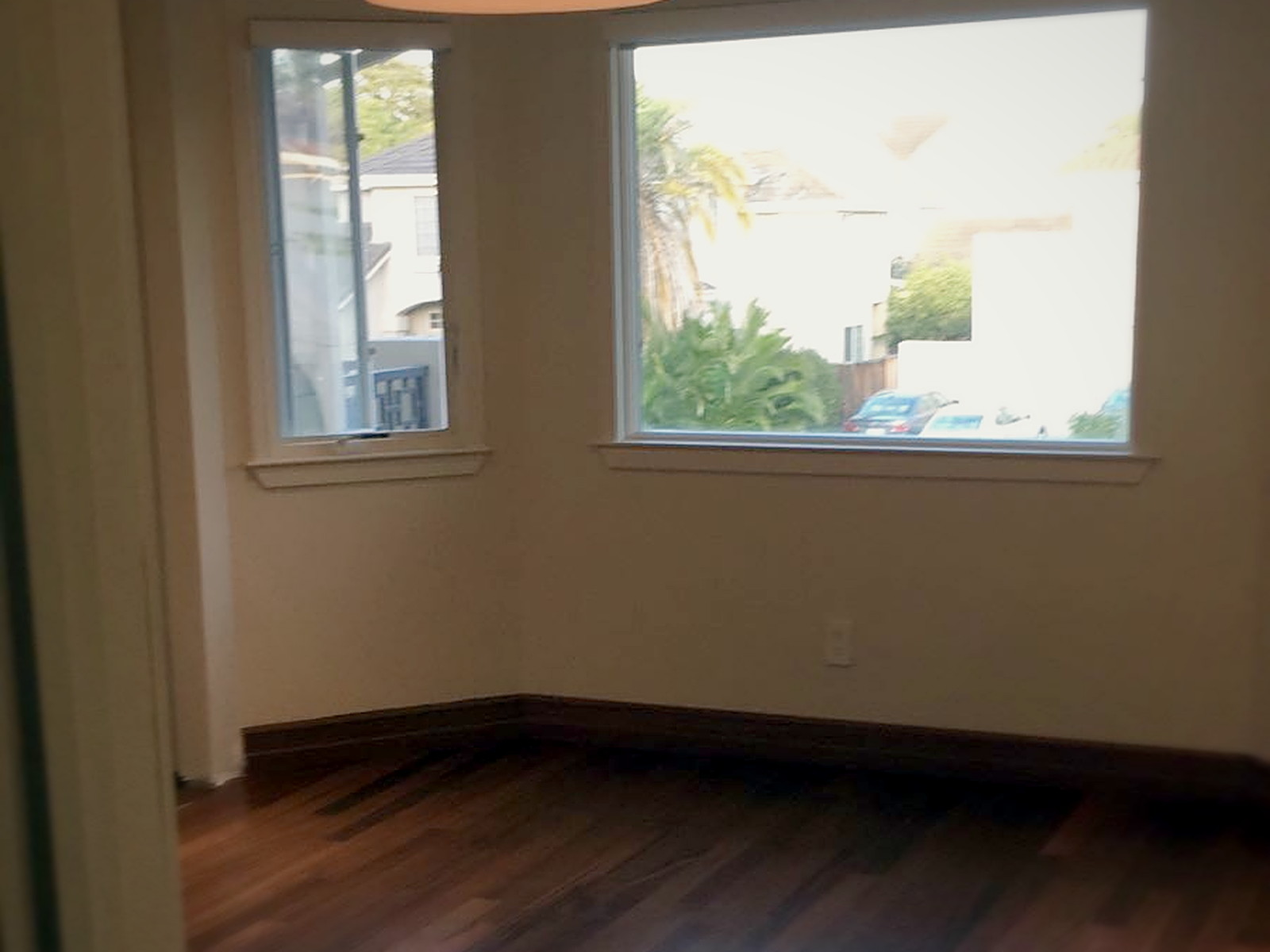Finished Melrose residential room with painted walls, soundproofed ceiling and new hardwood floor