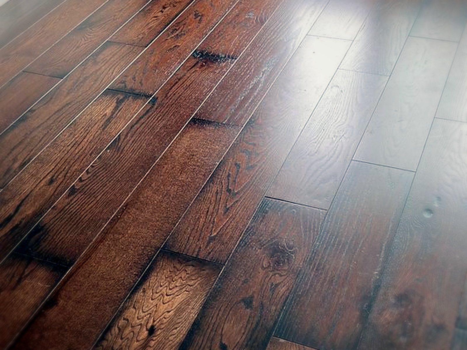 Close view of finished floated hardwood planks installed over acoustic underlay in a quiet upstairs room