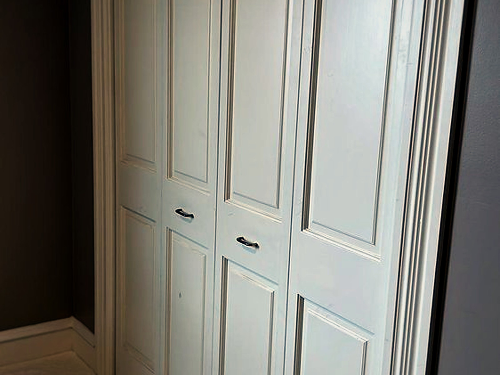 White panelled closet doors rehung with correct clearance above a newly installed soundproof carpet floor