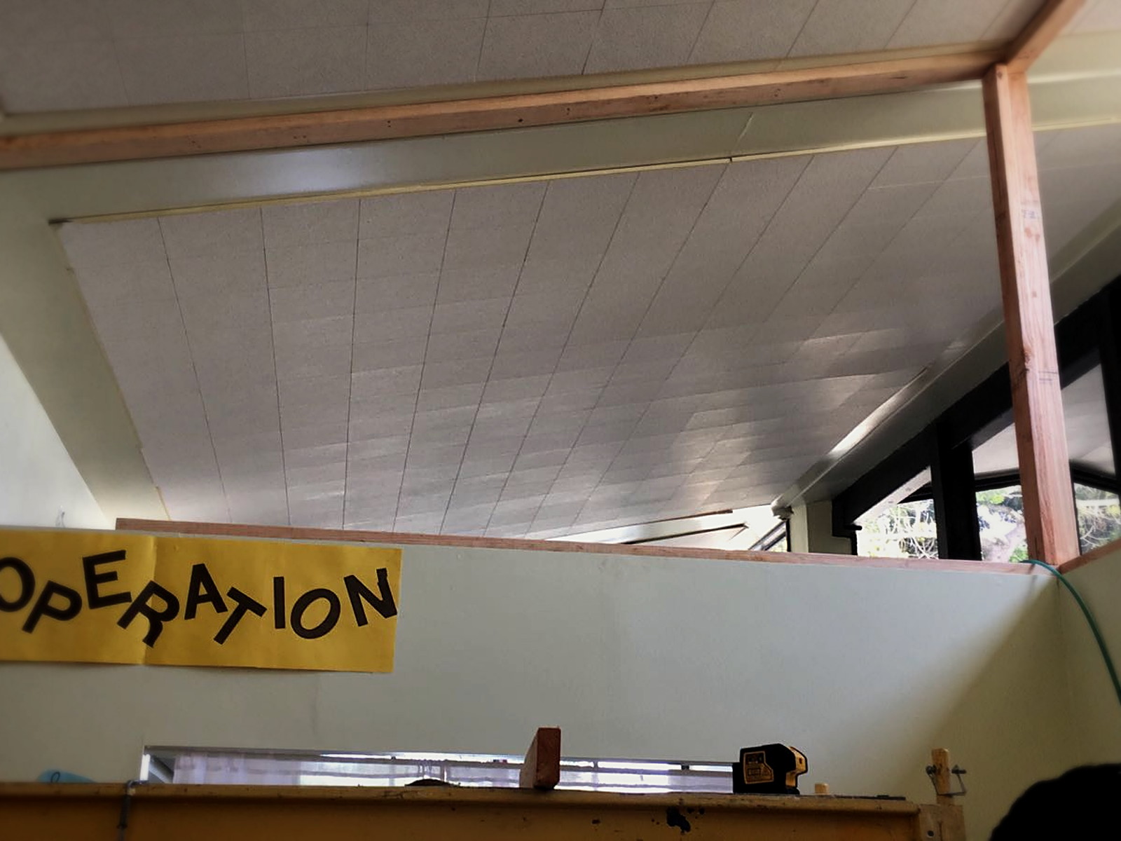 Bridges Academy classroom before soundproofing with an open transom gap above the shared partition wall