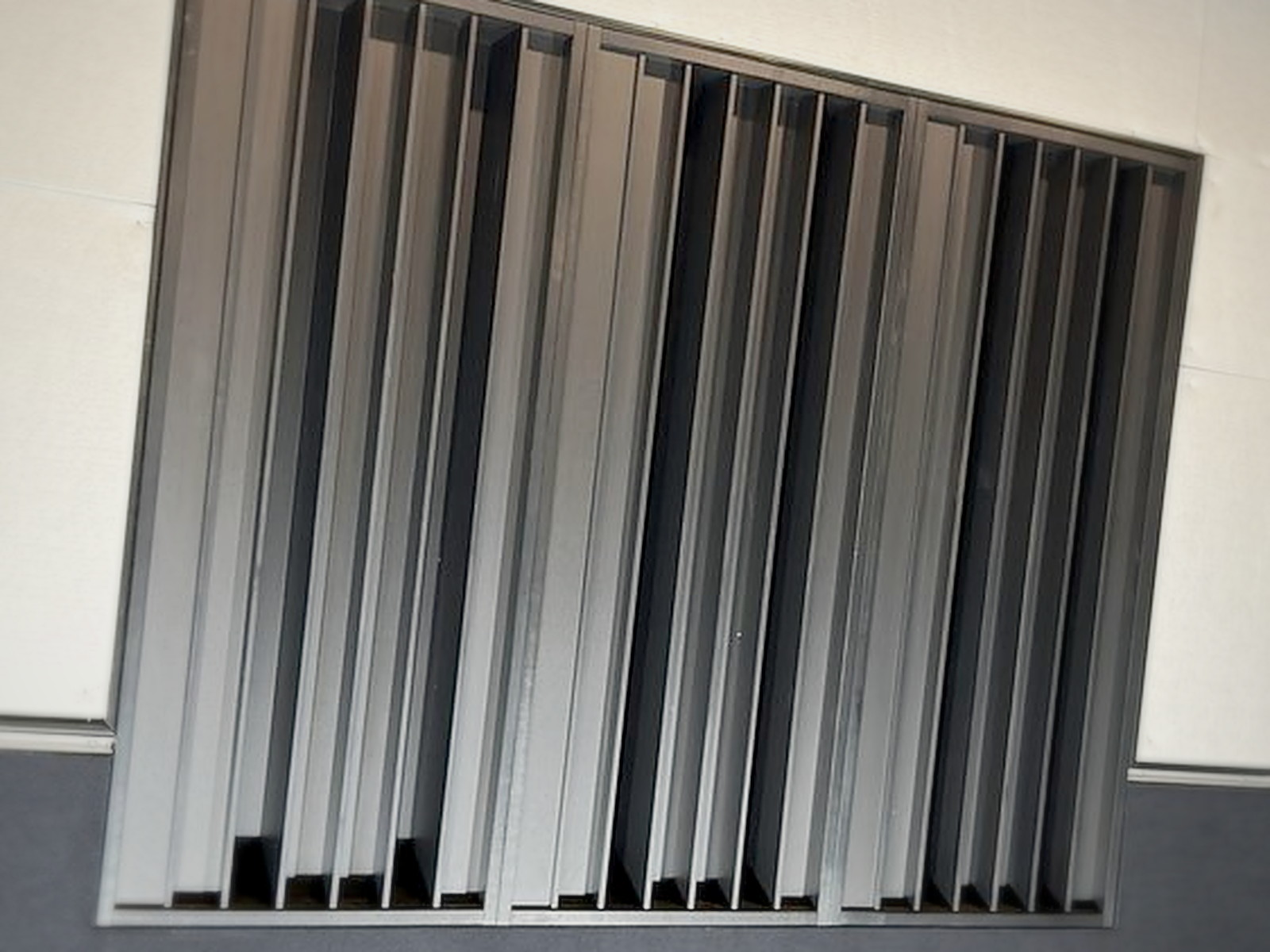 Finished black slat diffuser panel mounted above charcoal acoustic wall panels in a San Francisco recording studio