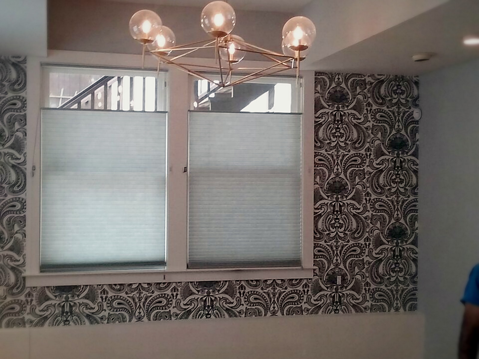 Finished soundproofed living room ceiling in Melrose with a pendant chandelier and hardwood floor