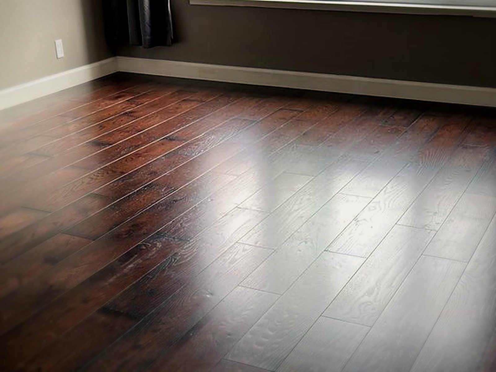 Finished floated hardwood floor over a soundproof underlay assembly in a San Francisco living room with bay window